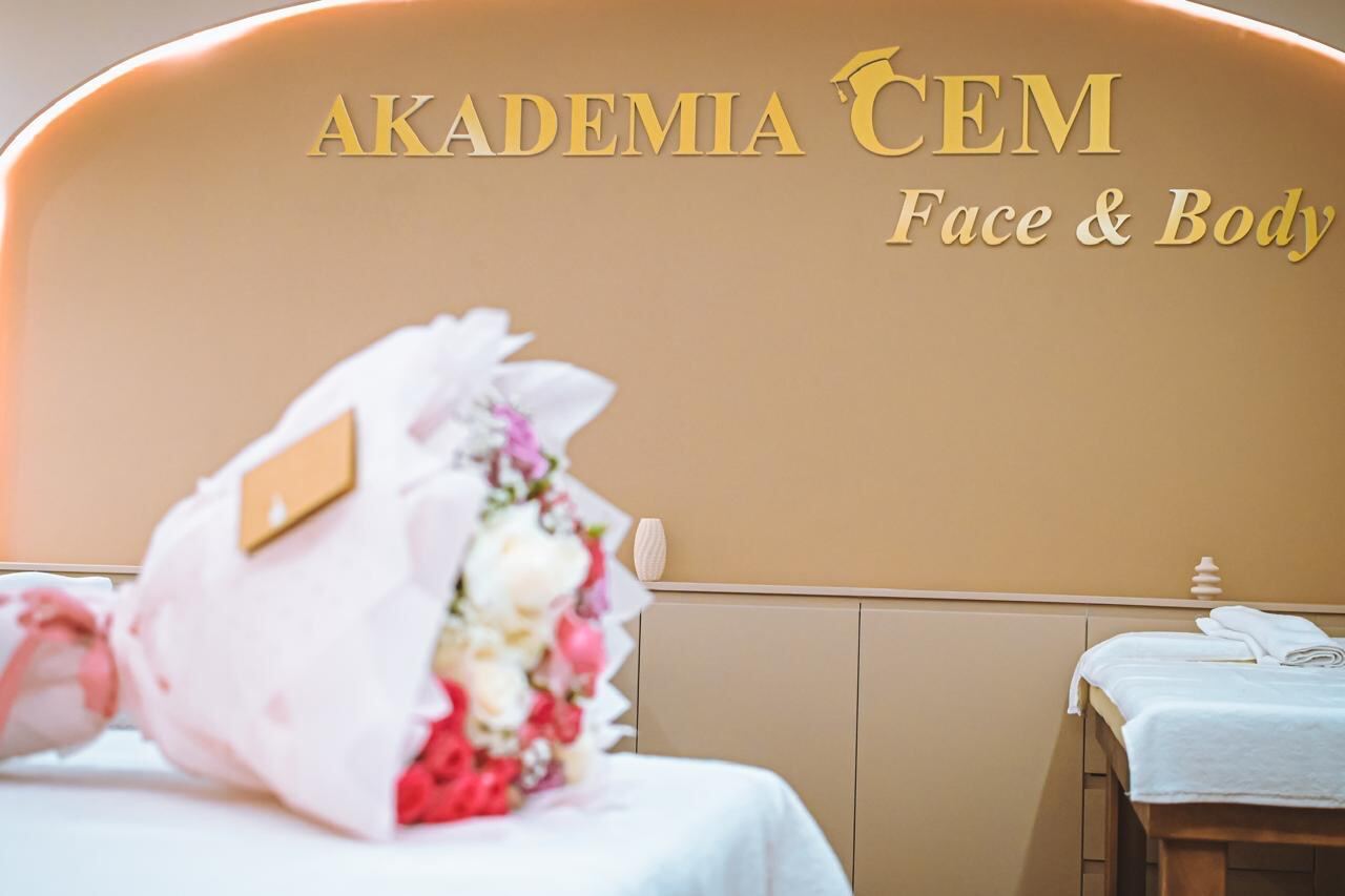 The Akademia CEM Face and Body treatment room, with the gold sign lit on the arched wall behind the beds.